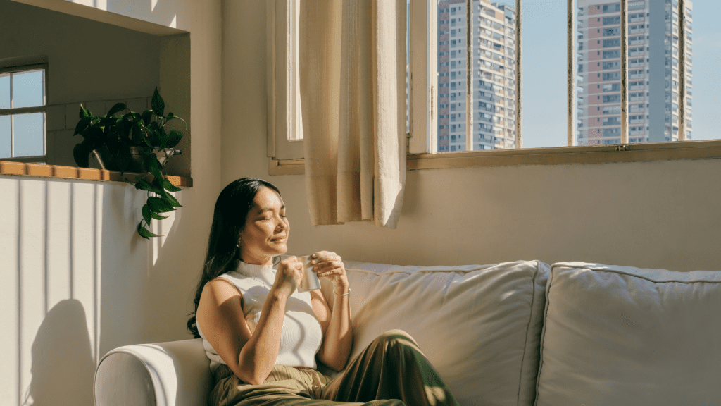 Woman with her eyes closed drinking coffee