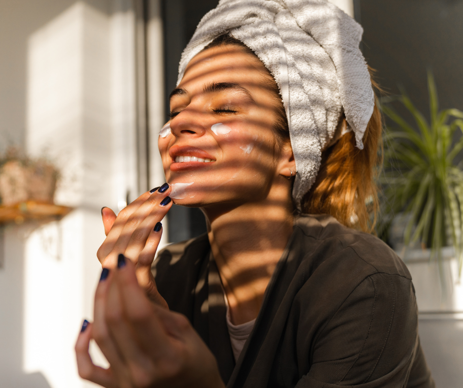 Woman putting skin care on her face
