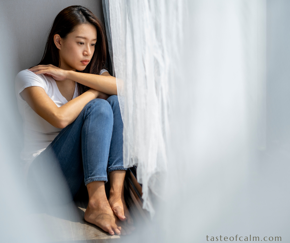 Sad woman is sitting on the floor