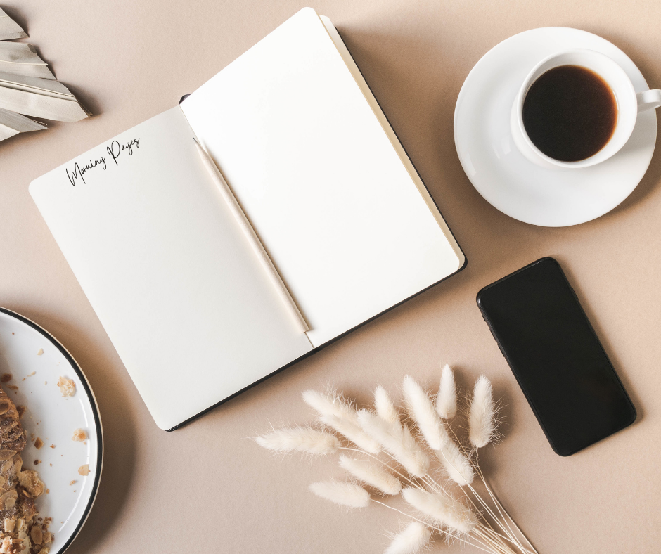 A Morning Pages journal and a pen on the desk