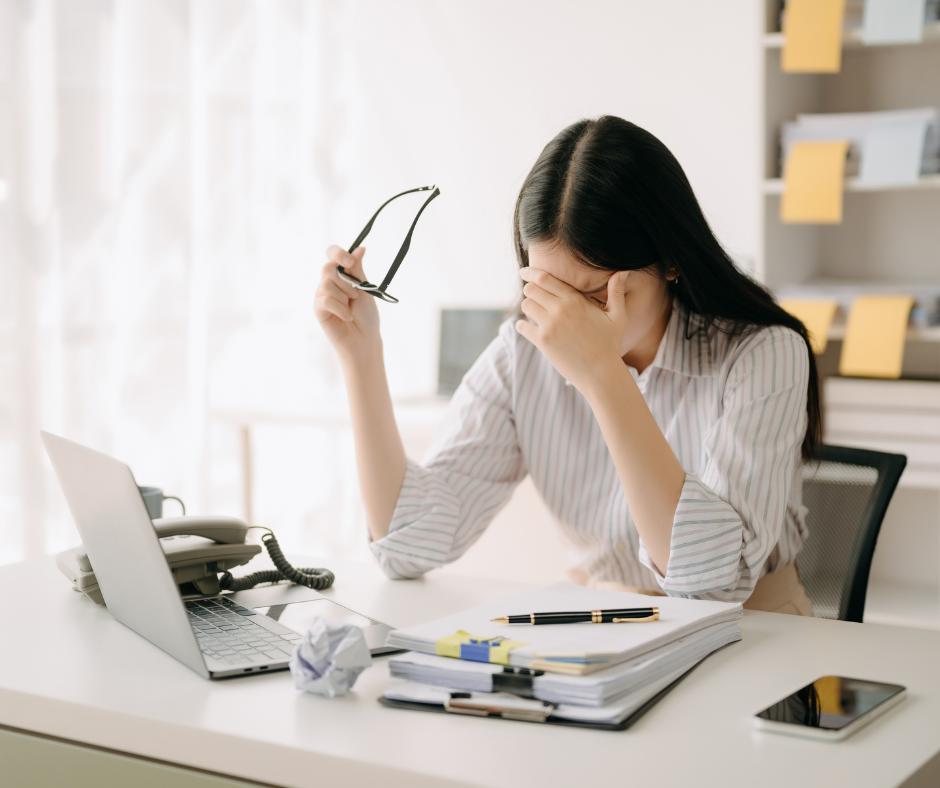 Woman thinking hard, sitting at the computer desk