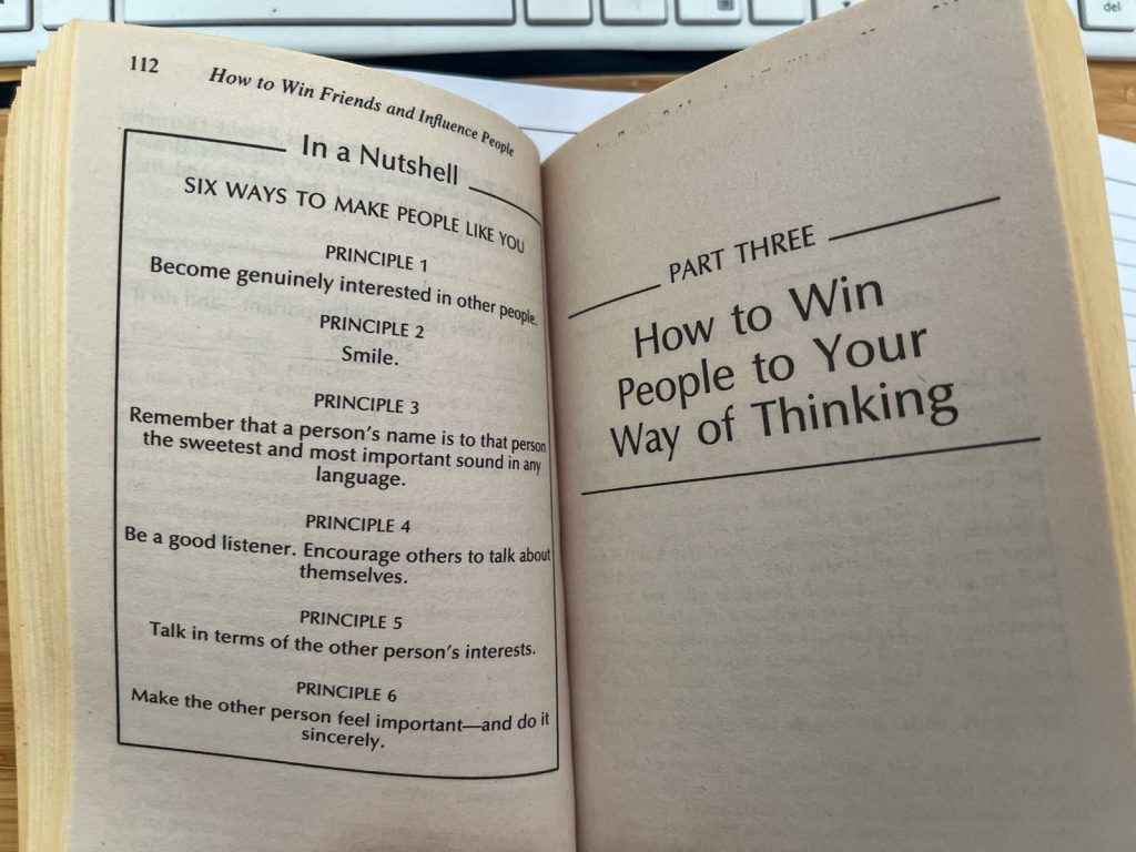 Book How to win friends and influence people open on the desk