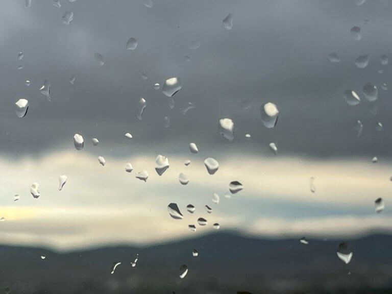 Photo of the rain drops on the window. Slow living habit of watching the rain