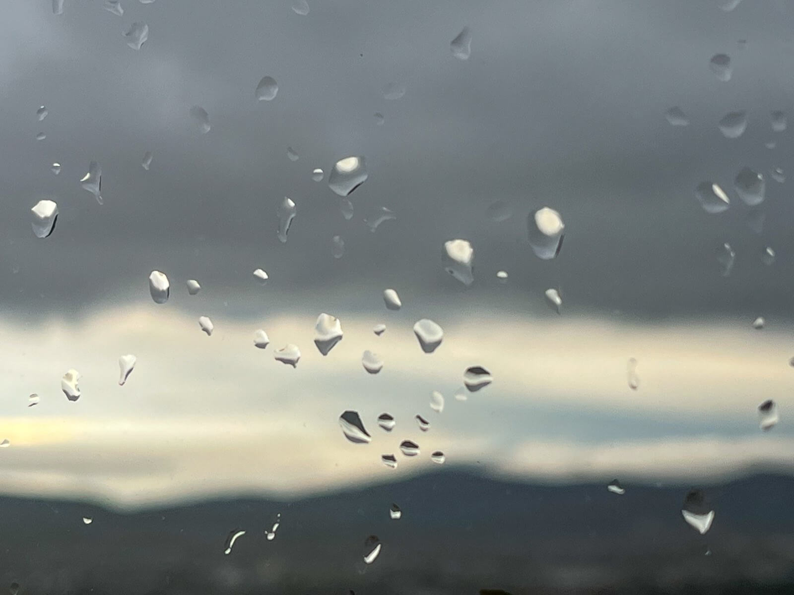 Photo of the rain drops on the window. Slow living habit of watching the rain