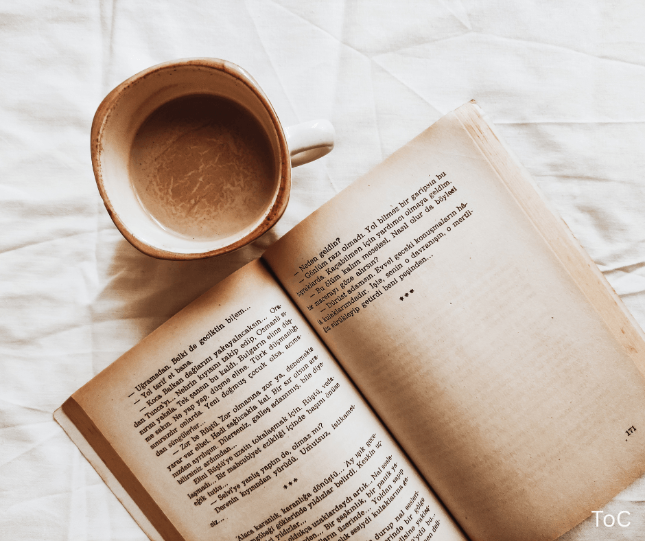 Photo of an open book and a coffee cup representing best habit books